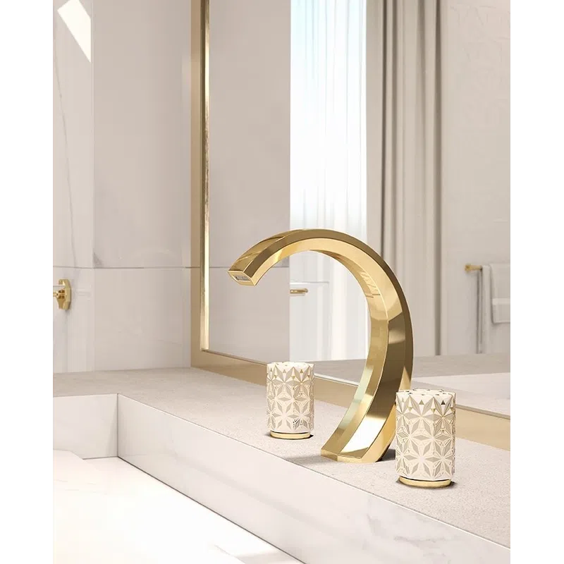 Elegant gold curved faucet with decorative textured handles on a beige bathroom countertop with mirror.