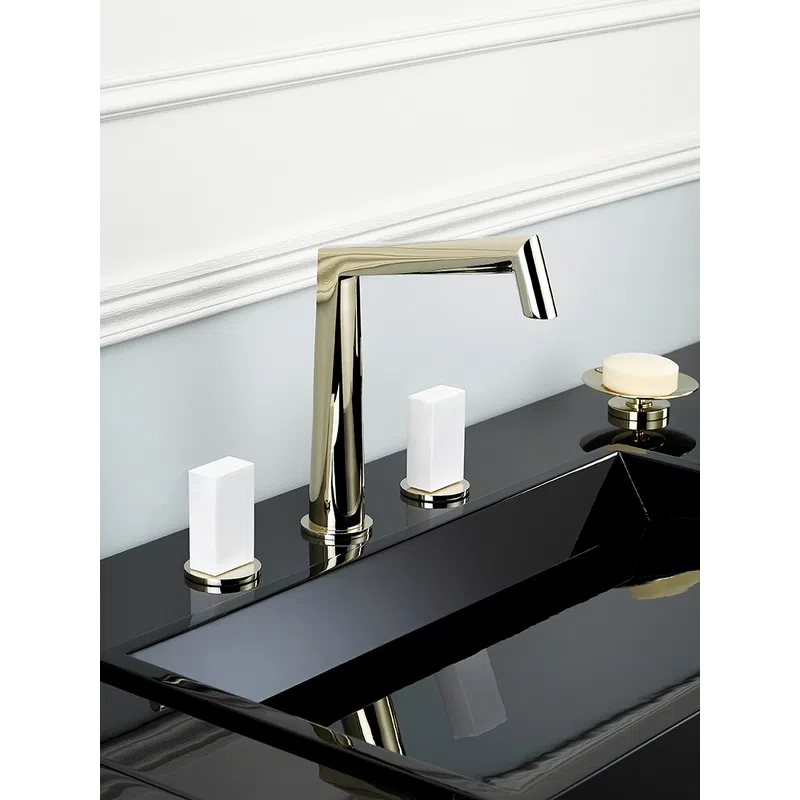 Modern black sink with a sleek silver faucet, white square handles, and soap dish on a bathroom counter.
