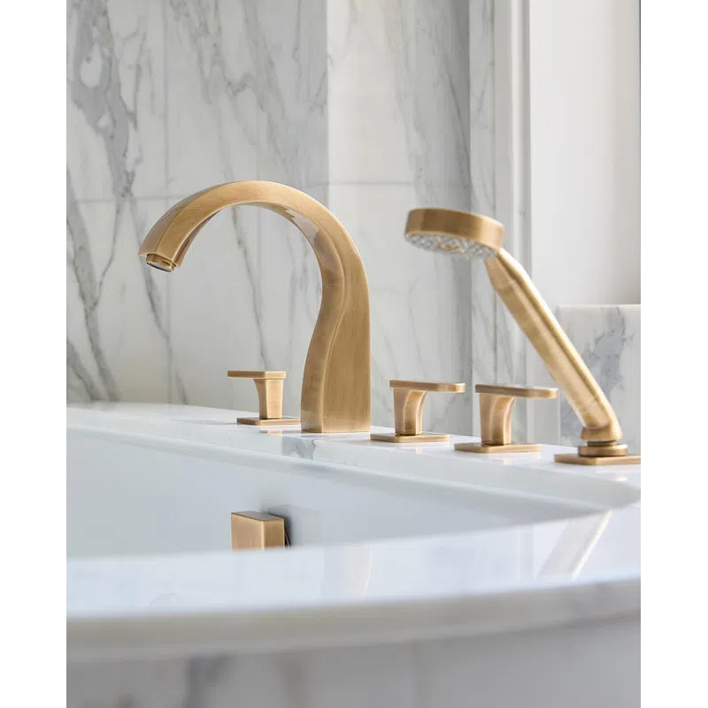 Modern bathroom with gold-tone faucet and hand shower set against white marble backdrop