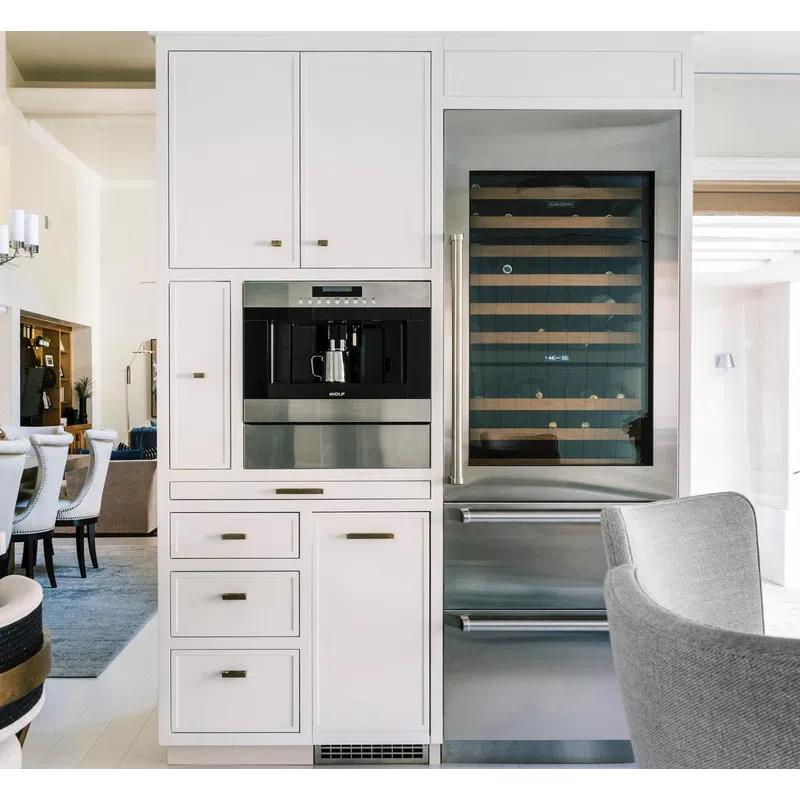 Modern kitchen cabinetry with built-in coffee machine and stainless steel wine fridge beside seating area.
