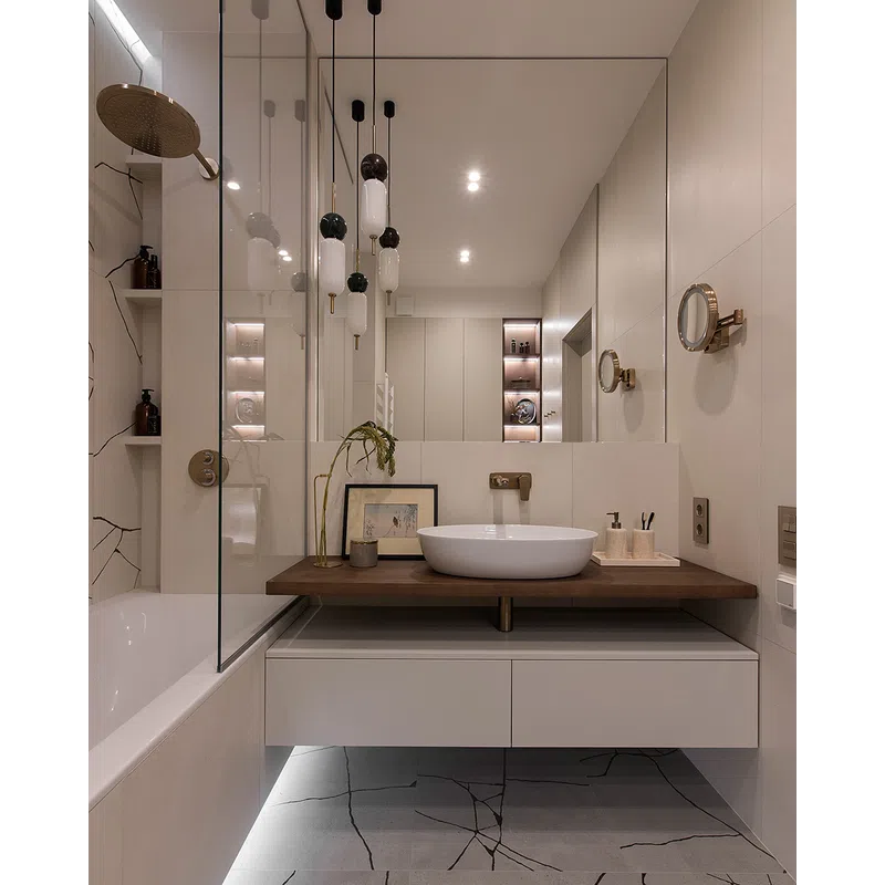 Modern bathroom with floating vanity, round vessel sink, wooden countertop, and large mirror with pendant lights.