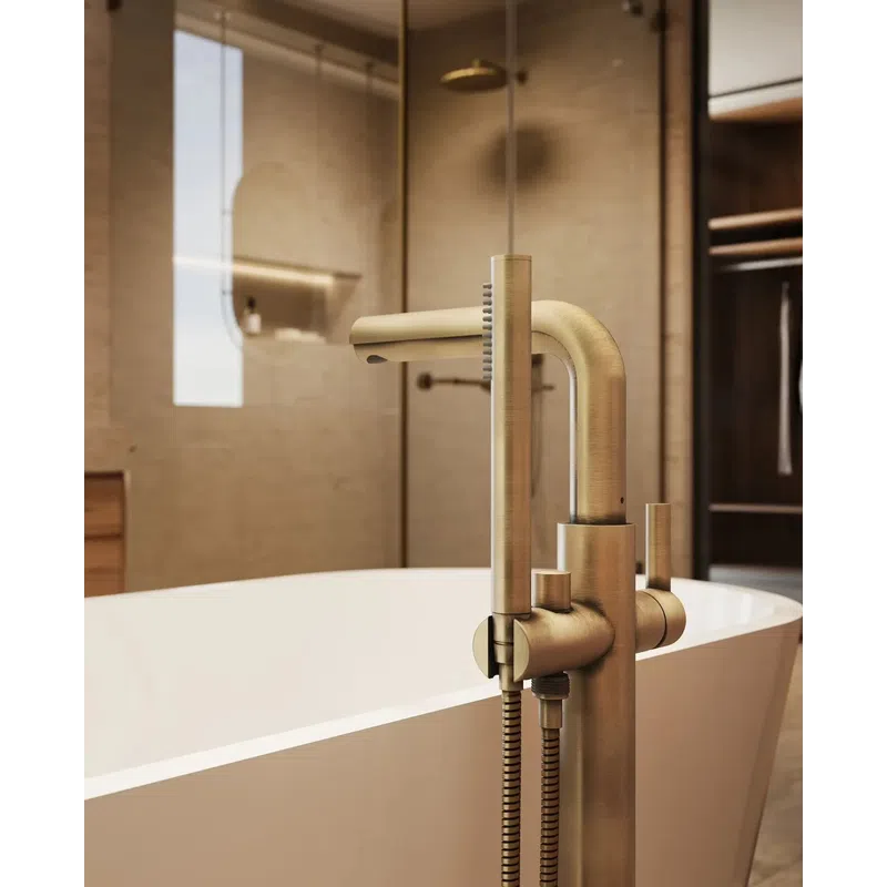 Modern brushed brass freestanding bathtub faucet with handheld shower in a stylish bathroom.