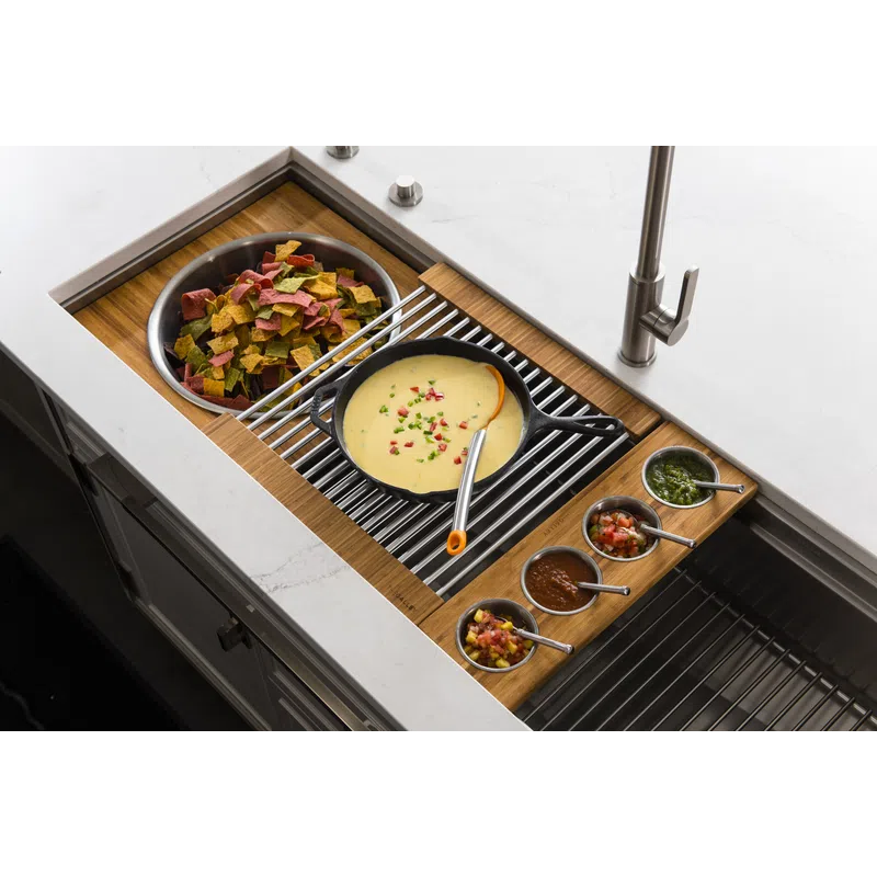 Kitchen sink setup with queso dip, multicolored chips, and four small bowls of different sauces on a wooden tray.