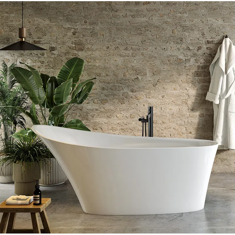 Modern white freestanding bathtub in rustic bathroom with plants, wooden stool, and hanging robe.