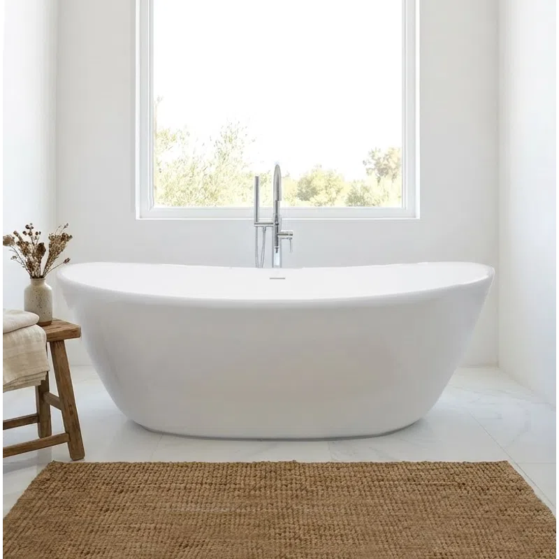 Modern white freestanding bathtub in a bright minimalist bathroom with a large window and natural decor.