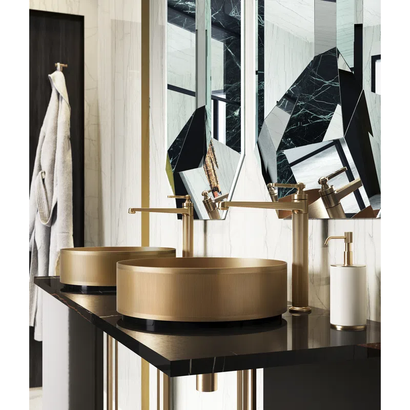 Modern bathroom with gold vessel sinks, geometric mirrors, marble walls, and black countertop with gold fixtures.