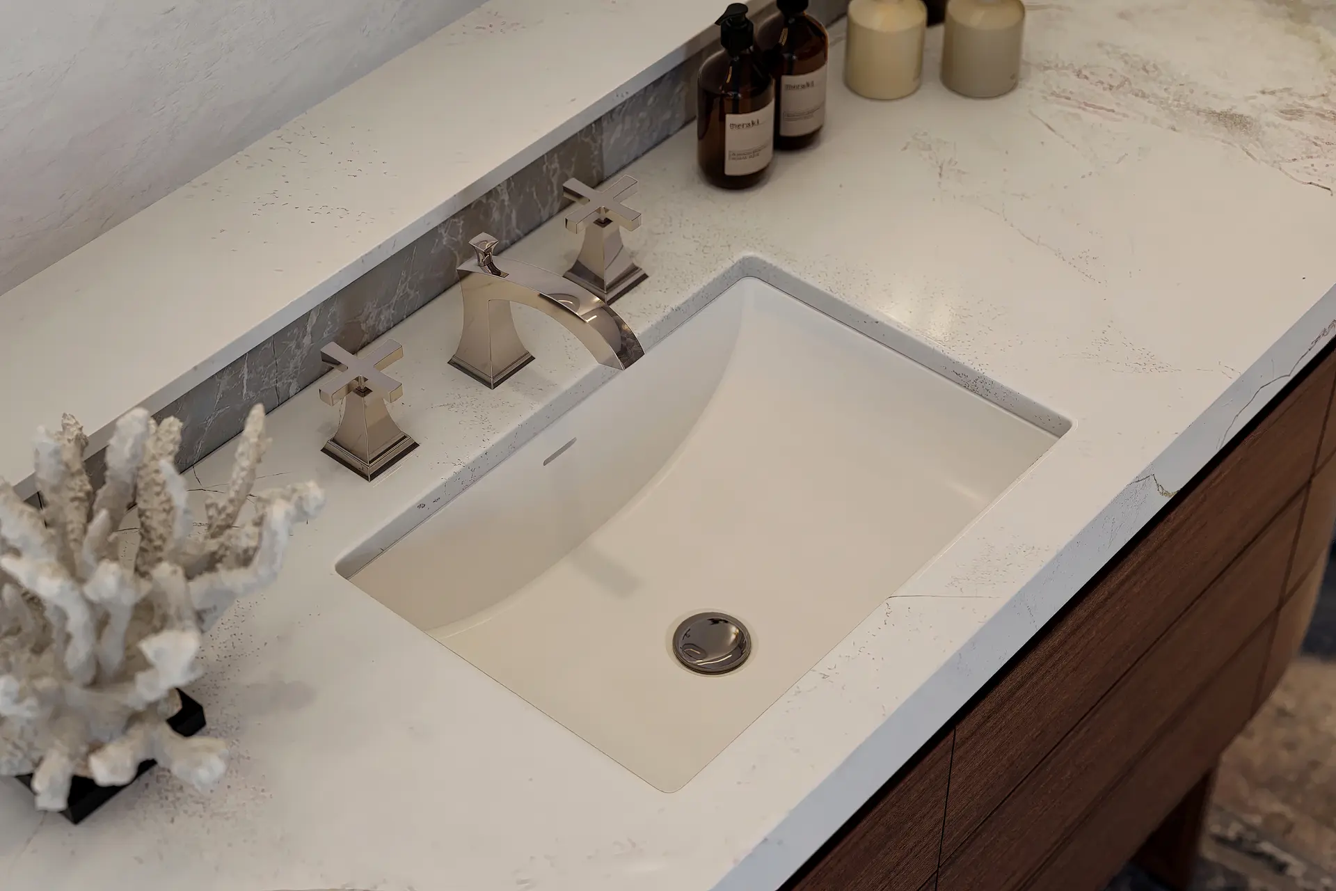 Crosswater Leyden widespread faucet in brushed nickel over an undermount basin in a marble vanity top.