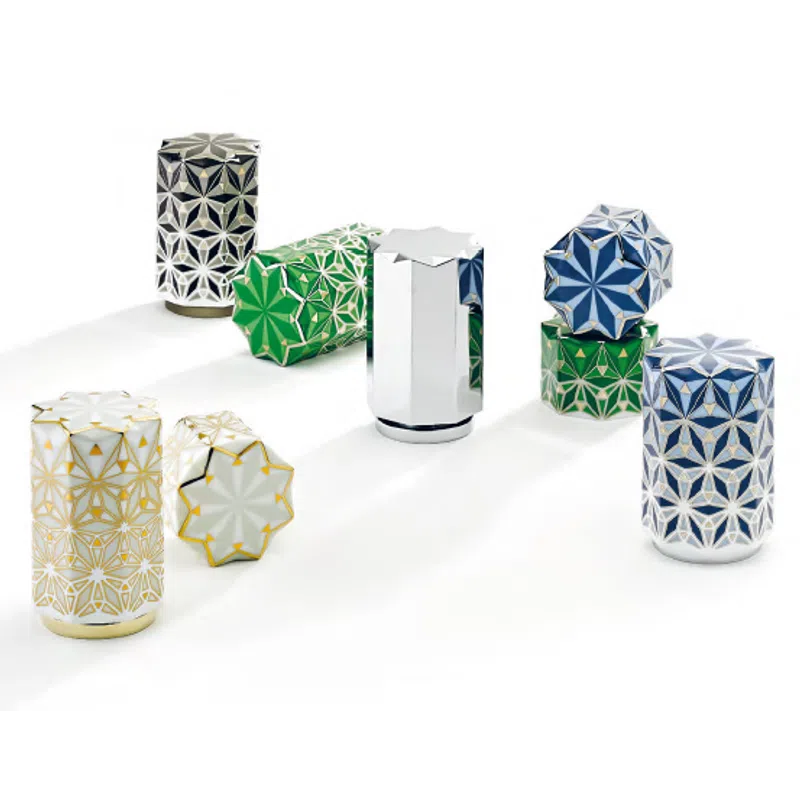 Decorative geometric patterned containers in blue, green, white, and silver with star-shaped lids on white background